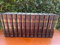 Row of 12 maroon hardcover books titled 'The Library Of Entertainment' volumes 1-12, with visible gold embossed titles on spine.