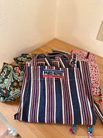 Front view of the blue striped Paris Bistro apron showing label and pattern