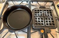 Cast iron skillet and Nordic Ware waffle iron on stovetop