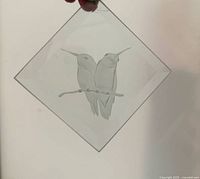 Photo showing the etched glass suncatcher held in hand to show design details and size.