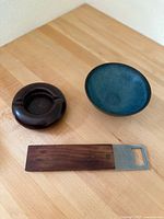 Bottle opener, bowl and ashtray on tabletop