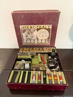 Full view of open Microcraft case showing microscope and contents