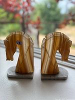 Pair of Trojan horse bookends from side and front showing natural stone banding and shape