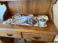 Overall view of china pieces on hutch shelf