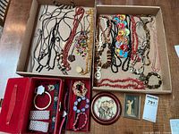 overview of all jewelry in trays, jewelry box and framed decor