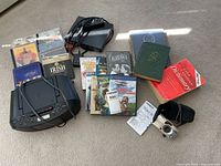 Overall lot showing Sony boombox, Blu-Ray player, DVDs, books and cords