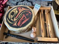 Boxed view showing drum, stand pieces, mallet, letter opener