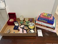 Tray showing crystals, spheres, pendulum, tools and books stack