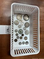 Overview of all coins in white plastic tray