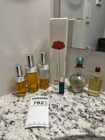 Overview of all seven perfume bottles and Kenzo box on countertop