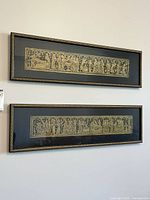 Both framed brass rubbings on wall