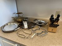 Overview of lot showing trays, mug, kettle, knife block, serving racks and dish