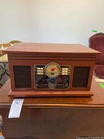 Closed Victrola entertainment center front view on table