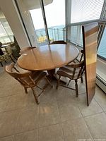 Round maple table with chairs and leaf