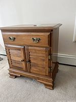 Front view showing drawer, doors, hardware and base