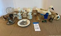 Group shot of entire lot on tabletop showing swan planter, cat, bird and other animal figures