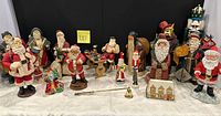 Full lot overview showing all Santa figurines, nutcracker, candle snuffers and accessories