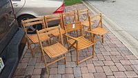 Front view of all seven folding chairs grouped together