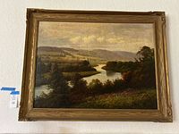 Framed landscape painting on wall