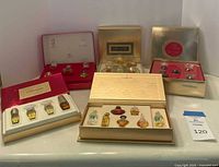 All five boxed perfume sets open displaying miniature bottles