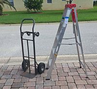 Overall view of ladder and hand truck on driveway