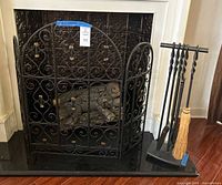 Entire lot beside fireplace showing tool set on stand and three-panel screen in place
