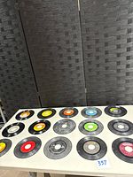 Full layout of 15 vinyl 45s on table