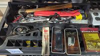Tray with assorted hand tools, packaged hardware visible