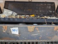 Closed Craftsman toolbox with rusted exterior and contents visible