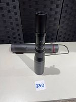 Full view of lens assembled with case in background