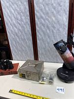 Full lot view showing telescope, binoculars, metal check file box and eyepieces