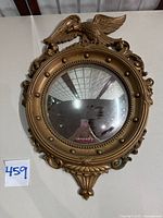 Front view of convex mirror showing full frame and eagle crest