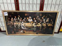 Full view of framed reproduction print leaning against wall