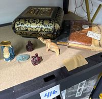 Overview showing wooden box, journals, figurines
