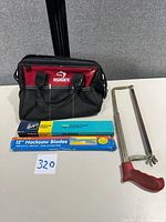 Overall lot showing Husky bag, hacksaw, two blade packs