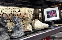 Full lot showing quartz, sandstone, bookends and framed print on shelf