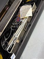 Closed case with cables, stands, manual visible