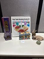 Group shot showing all boxed items, rabbit statue, marble frog