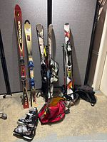 Group shot of all four ski sets, poles, boots and bags