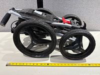 Cart folded, measuring tape for scale