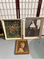 All three framed prints standing against backdrop