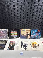 Eight album jackets laid out on table