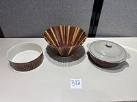 All three items side by side: wood fruit bowl, ceramic bowl, stoneware casserole with lid