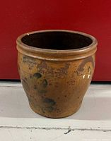 Front view of brown stoneware crock with cobalt floral decoration