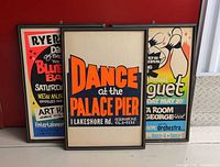 Three framed vintage Toronto dance posters leaning against wall