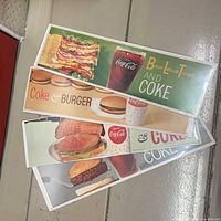 Stack of four shrink-wrapped horizontal posters