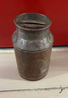 Full view of McClary metal farm can showing shape and rust