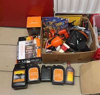 Full view of cardboard box with props and fog liquid jugs