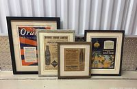 Group shot of all four framed ads standing side by side
