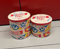 Two colorful cylindrical Humpty Dumpty chip cans side by side